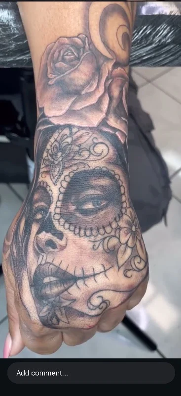 Benson Carlos black and gray sugar skull tattoo on hand in Hawaii