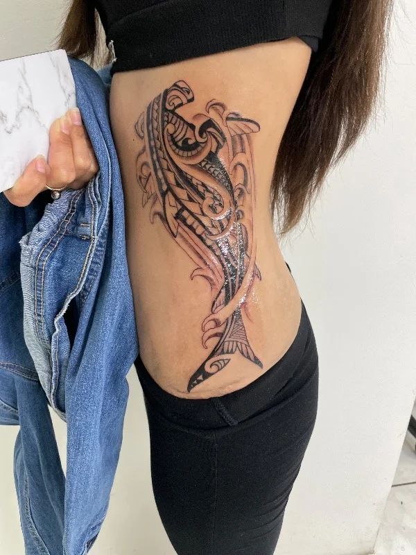Benson Carlos Polynesian tribal shark tattoo on ribs in Hawaii